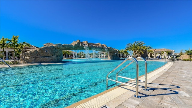 view of swimming pool with pool water feature