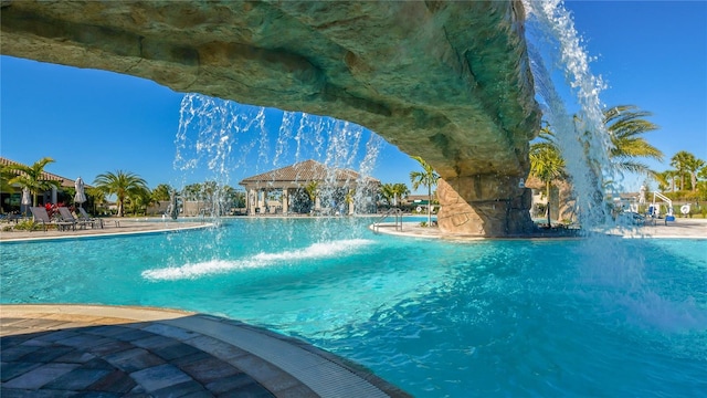 view of pool with pool water feature and a gazebo