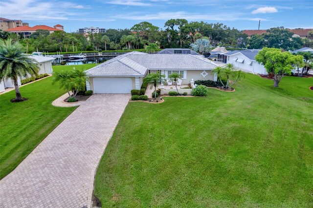 single story home featuring a garage and a front yard