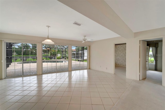 empty room featuring light tile patterned flooring and ceiling fan