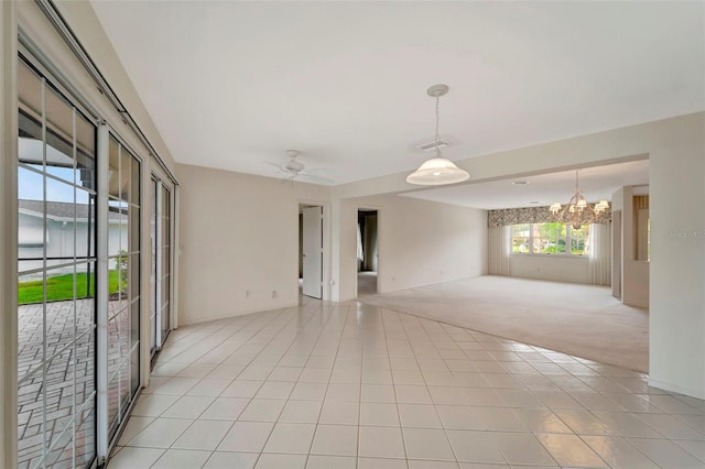 unfurnished room with light tile patterned flooring and ceiling fan with notable chandelier