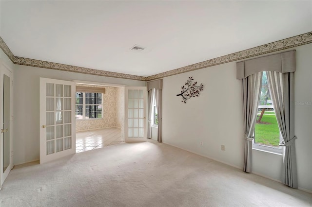 carpeted spare room with french doors