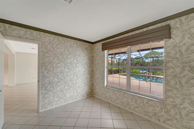 empty room featuring crown molding and light tile patterned floors