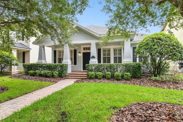 view of front of property with a porch and a front yard