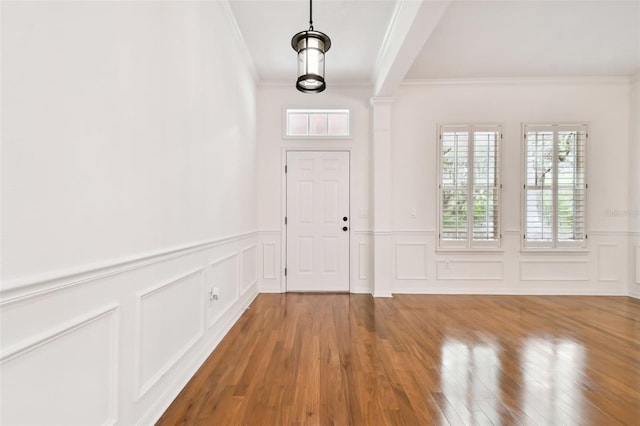 entryway with crown molding and hardwood / wood-style flooring