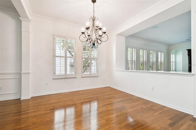 unfurnished dining area with hardwood / wood-style flooring, a chandelier, and ornamental molding