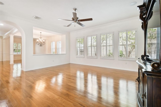 unfurnished living room with decorative columns, crown molding, light hardwood / wood-style floors, and ceiling fan with notable chandelier