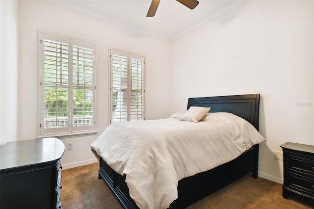 bedroom with dark colored carpet, ceiling fan, crown molding, and multiple windows