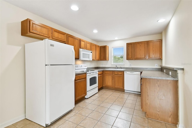 kitchen with light tile patterned flooring, white appliances, and sink