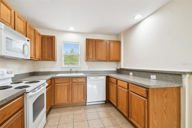 kitchen featuring white appliances, sink, and light tile patterned floors