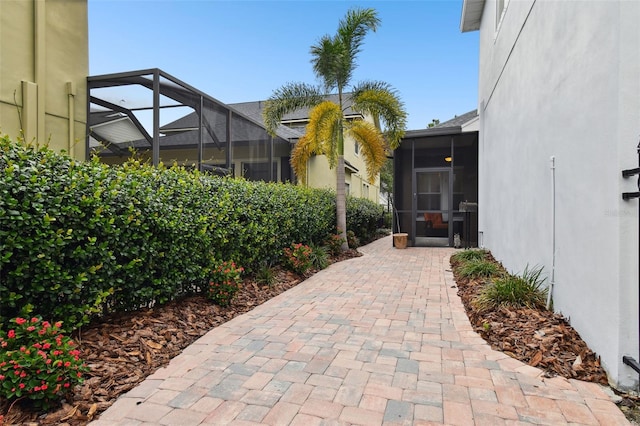 view of patio featuring a lanai