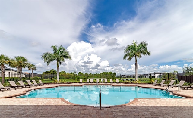 pool featuring a patio area and fence