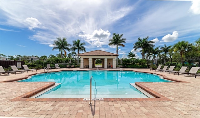 community pool featuring a patio and fence