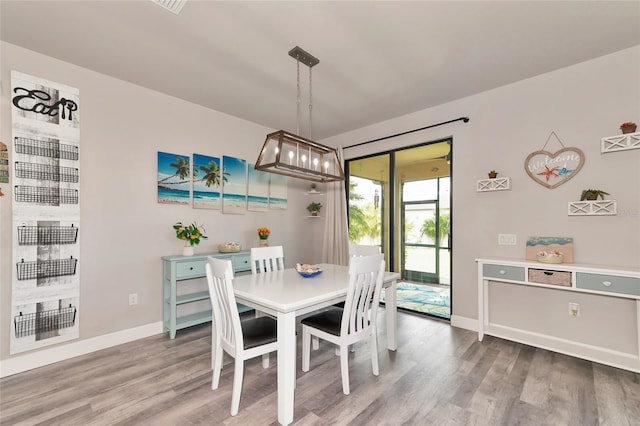 dining area with wood finished floors and baseboards