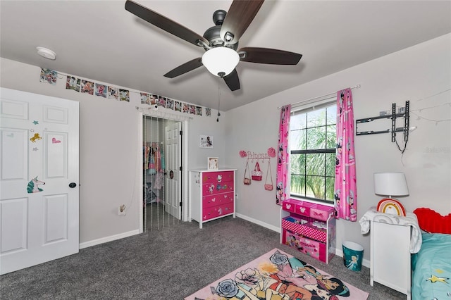 recreation room featuring baseboards and dark carpet