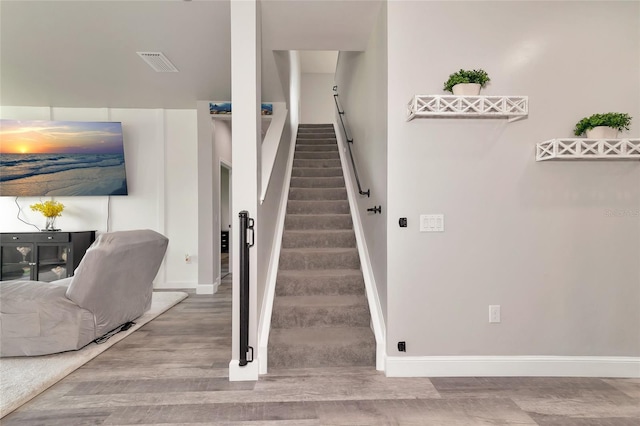 2352 Marton Oak Blvd, North Port, FL 34289 - stairs featuring wood finished floors and baseboards