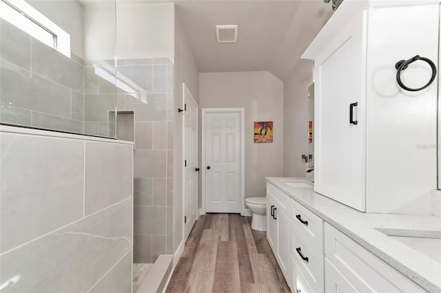 2352 Marton Oak Blvd, North Port, FL 34289 - bathroom featuring a walk in shower, wood finished floors, double vanity, and toilet