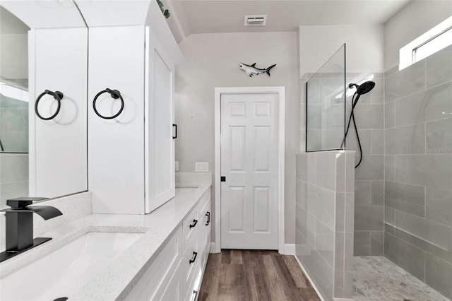 2352 Marton Oak Blvd, North Port, FL 34289 - full bath with a walk in shower, wood finished floors, and double vanity