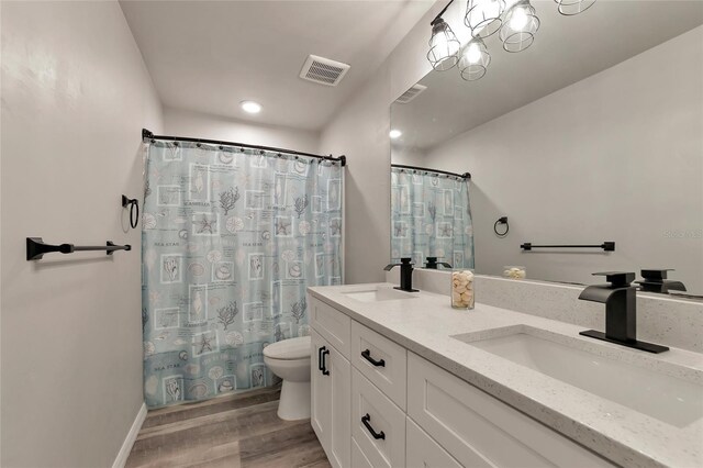 2352 Marton Oak Blvd, North Port, FL 34289 - bathroom featuring toilet, wood finished floors, double vanity, curtained shower, and recessed lighting
