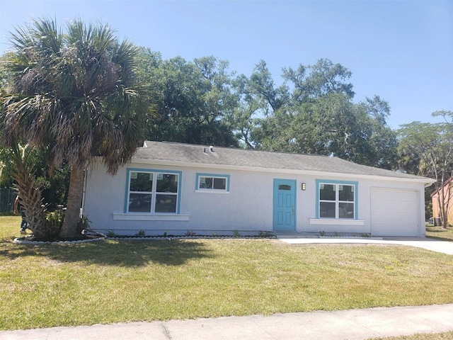 ranch-style house with driveway, a front lawn, and an attached garage