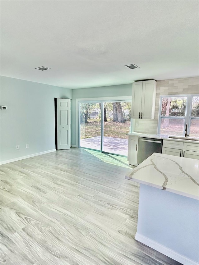 interior space with visible vents, a sink, and baseboards