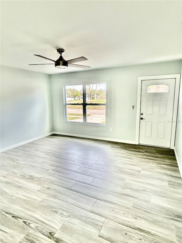 entryway featuring light wood-type flooring, baseboards, and a ceiling fan