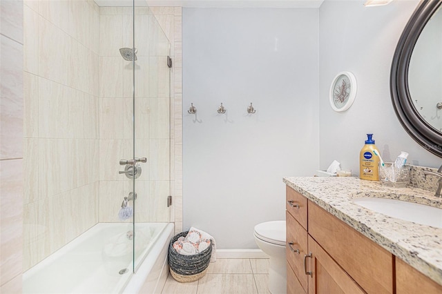 full bathroom featuring tile patterned floors, toilet, tiled shower / bath combo, and vanity