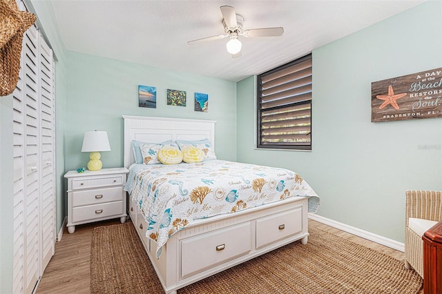 bedroom featuring ceiling fan and light hardwood / wood-style flooring