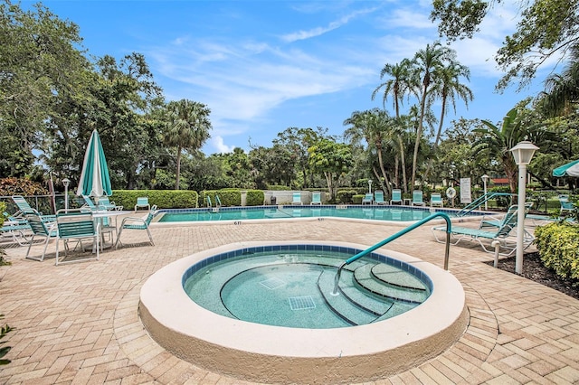 view of swimming pool with a patio area and a community hot tub