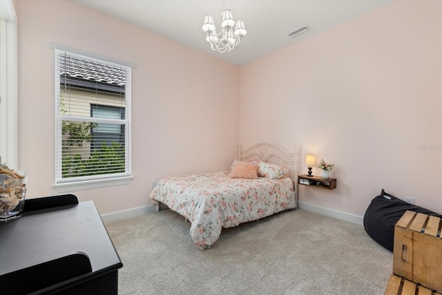 carpeted bedroom with a chandelier