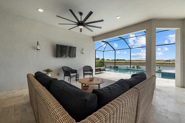 view of patio / terrace with an outdoor living space, ceiling fan, and a lanai