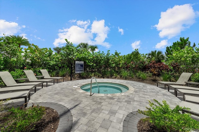 view of swimming pool with a patio and a hot tub