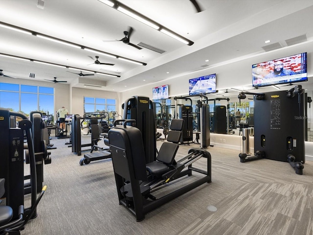 workout area with ceiling fan and light colored carpet