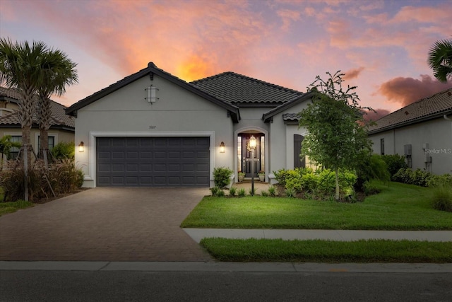 3107 Vittorio Ct, Bradenton, FL 34211 - view of front of home featuring driveway, a garage, stucco siding, a tile roof, and a front lawn