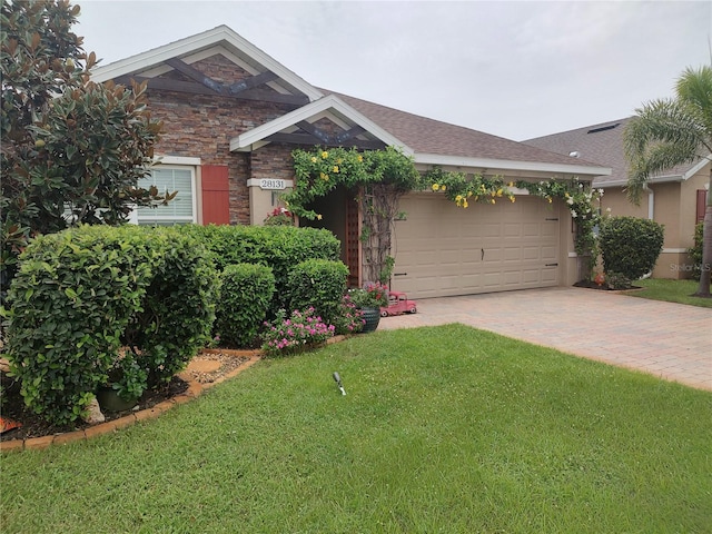 view of front of property with a garage and a front yard