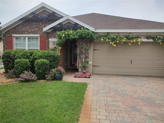 view of front of property with a garage and a front yard