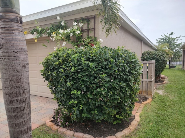 view of side of property with a garage and a yard