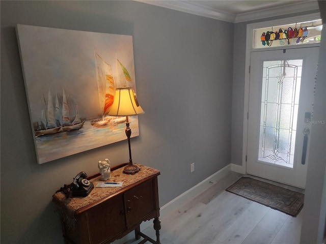 foyer with light wood-type flooring and crown molding