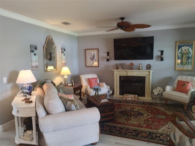 living room featuring crown molding, a fireplace, and ceiling fan