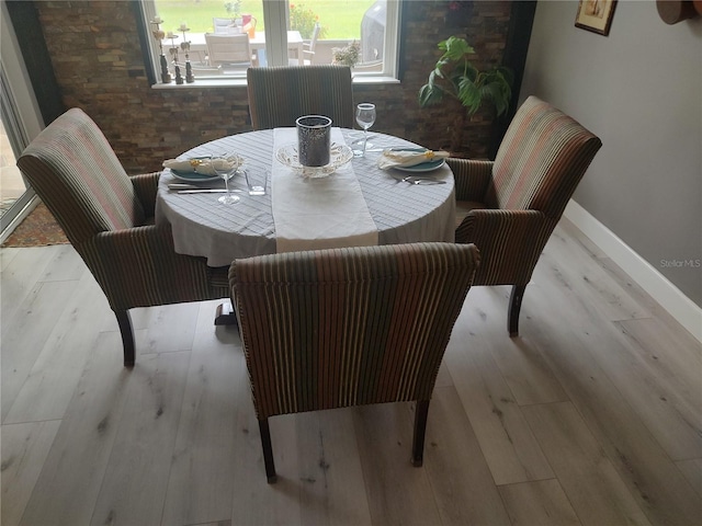 dining space with light hardwood / wood-style flooring