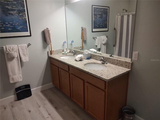 bathroom featuring a shower with shower curtain, hardwood / wood-style floors, and vanity