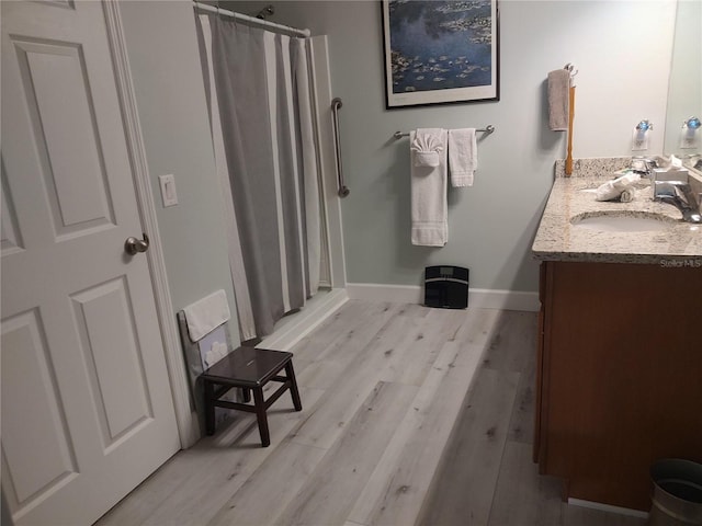 bathroom featuring vanity, hardwood / wood-style floors, and curtained shower