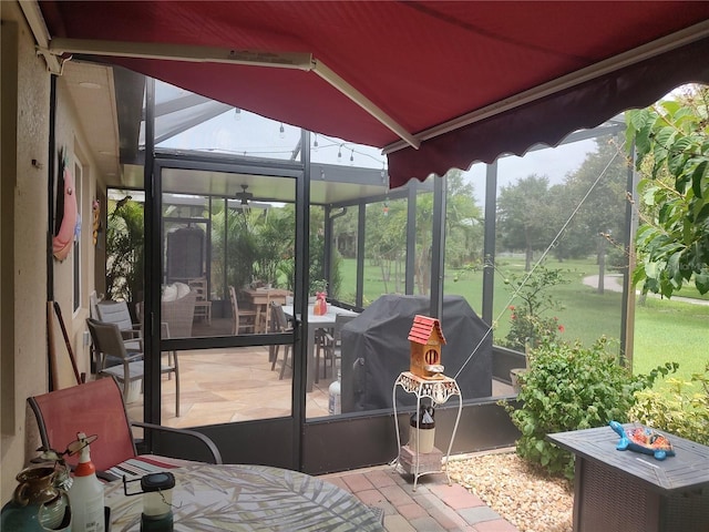 sunroom / solarium featuring lofted ceiling