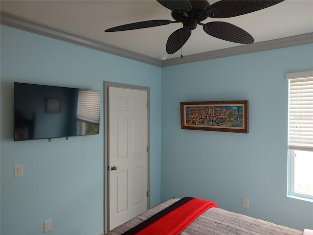 bedroom featuring multiple windows, crown molding, and ceiling fan