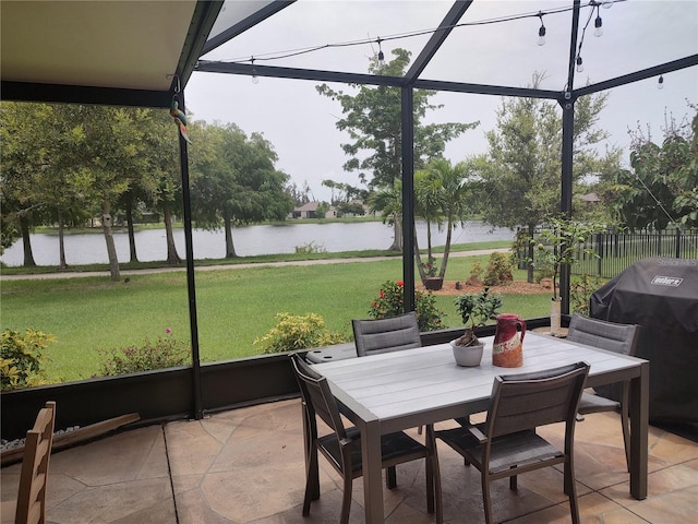 sunroom featuring a water view and a healthy amount of sunlight