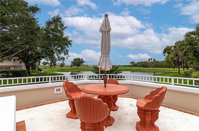 view of patio with a water view and a balcony