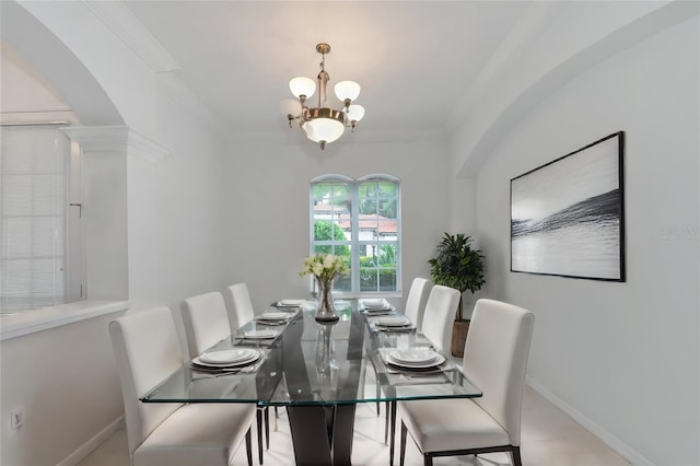 dining space with a chandelier, baseboards, and ornamental molding