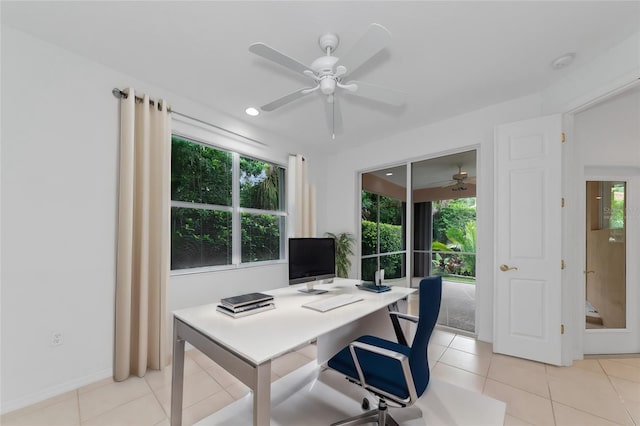 office area with light tile patterned floors and ceiling fan