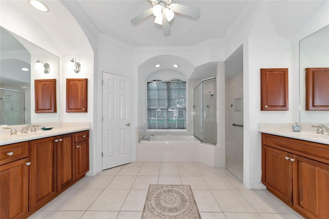 full bathroom featuring two vanities, a stall shower, crown molding, and tile patterned flooring