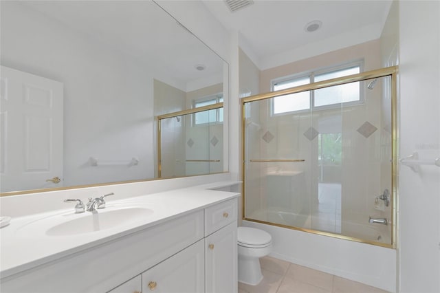 full bathroom featuring tile patterned flooring, visible vents, toilet, shower / bath combination with glass door, and vanity